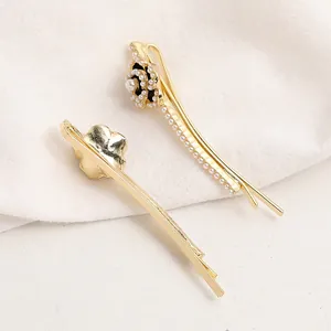 Elegant gold camellia hair clips with pearls and enamel for women's hair styling