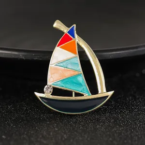 Creative enamel sailing ship brooch with gold frame and colorful vintage nautical design