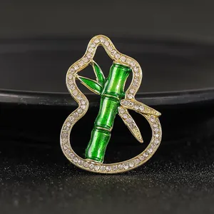 Elegant emerald green bamboo and gourd brooch in gold-plated hollow design for women