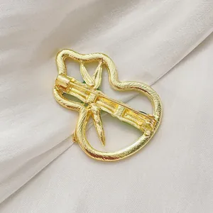 Gourd-shaped emerald green bamboo brooch in gold plating with textured metallic finish