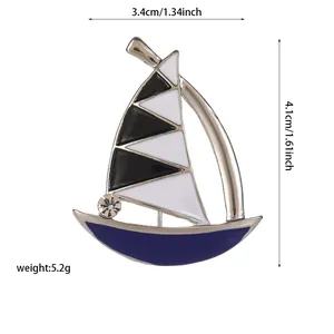 Detail view of enamel sailing boat brooch showing size 3.4cm x 4.1cm and silver finish
