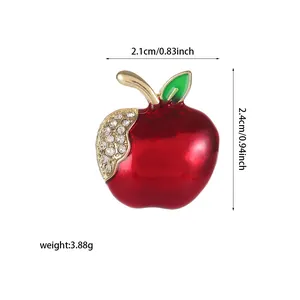 Detail view of apple brooch with red enamel, crystal accents and size 2.1x2.4cm