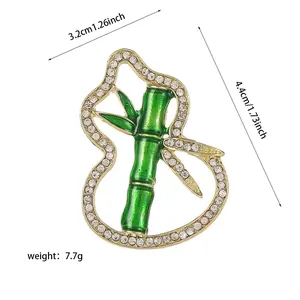 Detailed view showing dimensions of a green bamboo and gourd brooch with crystals