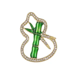 Elegant emerald green bamboo and gourd brooch in gold finish with white crystal inlay