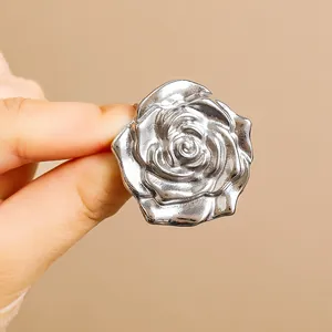 Polished silver rose ring with multilayered metal petals shown from a high-definition angle