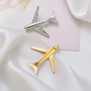 Airplane brooches in gold and silver finish with Good Luck engraving and crystals