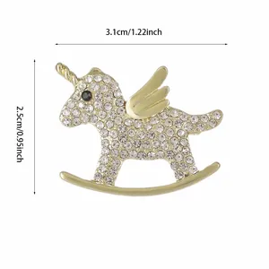 Detail view of unicorn brooch with gold alloy base and white crystals, size 3.1x2.5cm