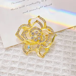 Détails d'une broche rose dorée avec cristaux scintillants et pierres centrales irisées