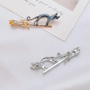 Cute enamel cat riding broomstick brooch with rhinestones and gold-plated finish