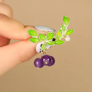 Exquisite blueberry plant brooch with golden branch, green leaves and purple beads