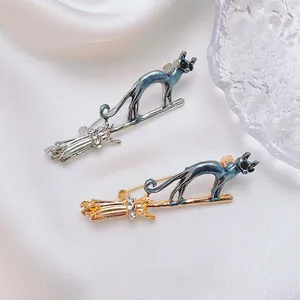Chic cat on broomstick brooches in gold and silver finish with sparkling crystals
