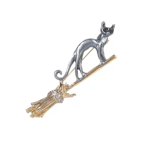 Charming flying cat on broomstick brooch in silver and gold alloy with crystals