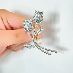 Elegant silver tulip brooch with shimmering rhinestones and a white pearl accent