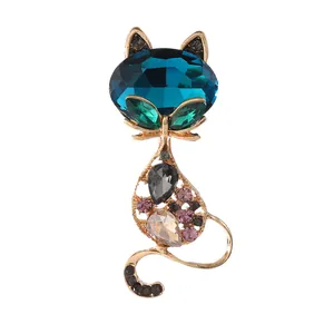 Luxurious cat brooch with blue crystal head and colorful rhinestones on gold base