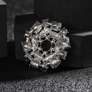 Luxurious silver flower brooch with green crystals and multi-layer rhinestone inlay detail