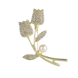 Elegant tulip flower brooch with sparkling crystals and a white pearl on golden base