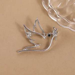 Minimalist silver hollow peace dove brooch with olive branch and black diamond eye detail