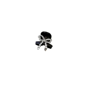 Elegant black hair claw clip with rhinestone bow and pearls for women's hair styling