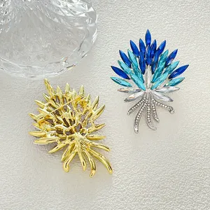 Elegant wheat stalk brooch with blue crystals shown from front and back view