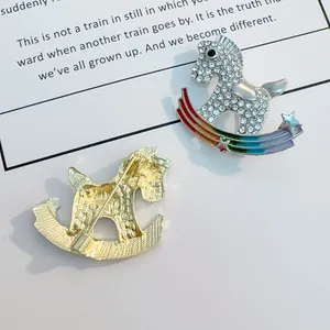 Rocking horse brooch with silver crystal pavé and rainbow gradient base detail