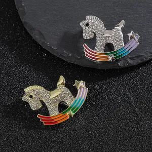 Rocking horse brooch with crystals and rainbow enamel in gold and silver finish