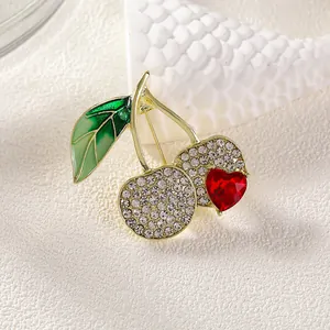 Elegant cherry brooch with sparkling rhinestones and red heart crystal on gold base