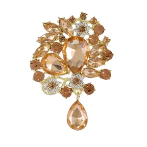 Broche fleurie élégante plaquée or avec cristaux ambre en goutte et strass champagne