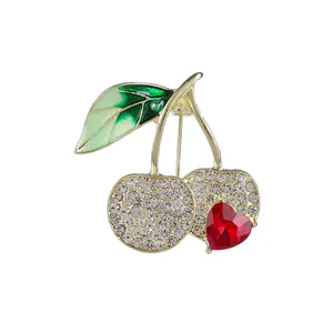 Sparkling cherry brooch with crystal rhinestones and red heart gem on gold base