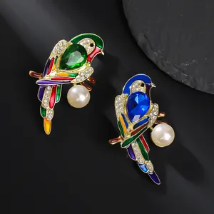 Exquisite parrot brooches with enamel, rhinestones and pearls on a dark background