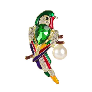 Exquisite parrot brooch with colorful enamel, green gemstone, and pearl on golden branch