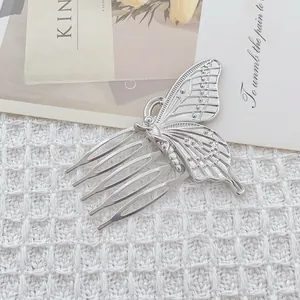 Elegant silver butterfly hair comb with five teeth on a stylish white textured background
