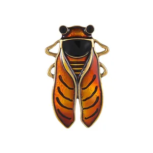 Vintage zinc alloy cicada brooch with amber orange enamel wings and retro gold finish
