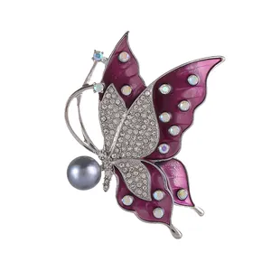 Silver butterfly brooch with purple enamel wings, white crystals and a grey pearl bead