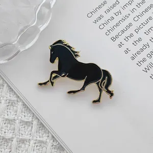 Close-up detail of a running horse enamel brooch pin in black and gold finish