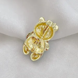 Golden panda silhouette brooch back view with pin fastener on white silk background