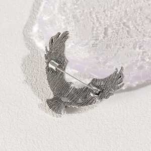 Sleek silver eagle brooch for men featuring detailed wings and back pin mechanism