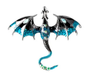 Detail of silver dragon brooch with teal enamel wings and sparkling inlaid rhinestones