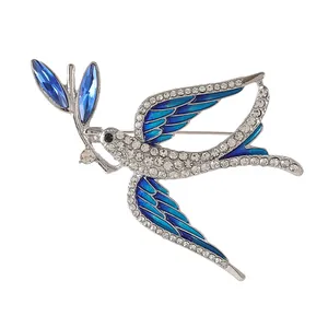 Elegant silver swallow bird brooch with blue enamel wings and sparkling rhinestones