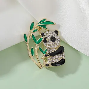 Detail of panda brooch with sparkling rhinestones and green bamboo leaves