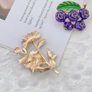 Artistic daisy enamel brooches with purple berries and golden leaf floral details