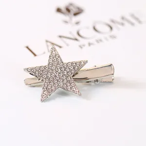 Sparkling star hair clip featuring white rhinestones and a silver alloy alligator base