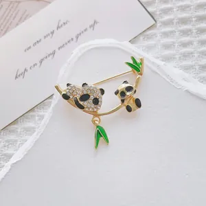 Macro shot of a panda brooch with sparkling rhinestones on golden bamboo branches