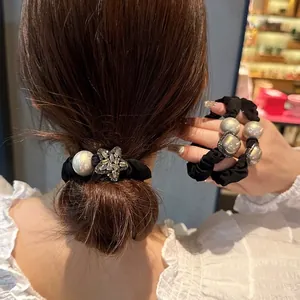 Elegant black scrunchie with grey faux pearl and sparkling rhinestone star hair tie