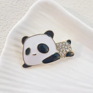 Macro detail of cute panda brooch with black white enamel and sparkling crystal rhinestones