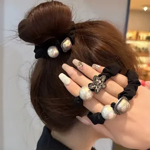 Elegant black scrunchie with large pearls and sparkling rhinestone star and square charms