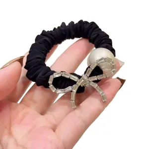 Elegant black scrunchie with white pearl and sparkling rhinestone butterfly charm