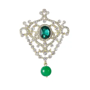 Elegant vintage gold crown brooch with emerald crystal and sparkling rhinestones