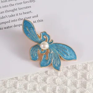 Elegant blue enamel butterfly hair clip with pearl center on gold metal alloy base