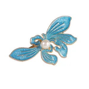 Blue alloy orchid butterfly hair clip with gold edges and white pearl centerpiece
