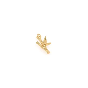 Macro detail of 18K gold plated bamboo leaf pendant with sparkling cubic zirconia